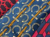 several different colored ties are lined up together on a table