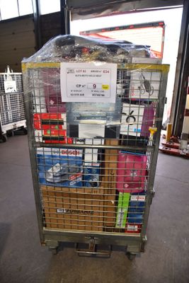 a metal cart with many items in it in a warehouse