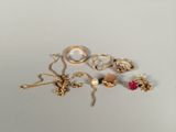 a lot of gold jewelry on a white surface