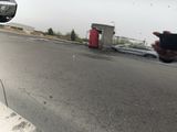 a man taking a picture of himself in the mirror of a car