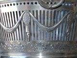 a silver vase that is sitting on a table