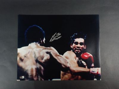 an autographed photograph of a boxer with a red boxing glove