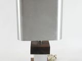 the lamp is made of wood and metal with a square shade on it