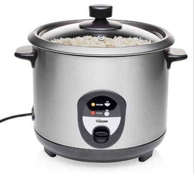a rice cooker with rice in it on a white background