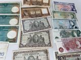 many different types of bank notes laid out on a table