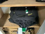 a black umbrella sitting on top of a shelf in a closet
