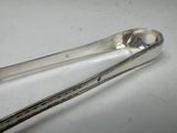 a spoon and tonget sitting on a table