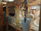 a wooden shelf with a bunch of glass vases on it
