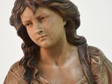 a statue of a woman sitting on top of a table