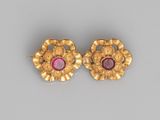 a pair of gold and ruby earrings