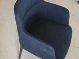 a blue chair sitting in the middle of a room