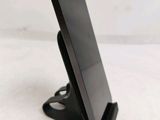 a cell phone that is on a stand on the table