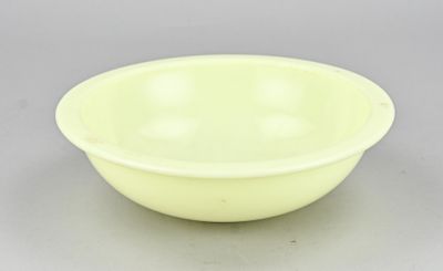 yellow plastic bowl on a gray background
