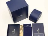 a blue box that has a watch and other items in it