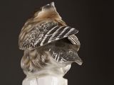 a figurine of a bird with a hat on it ' s head