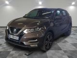 the front of a brown nissan qxv parked on a checkered floor
