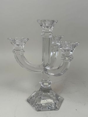 a clear glass candle holder on a white table