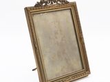 an old picture frame with a picture on it on a white surface