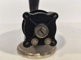 a close up of a black and silver fire hydrant on a white table