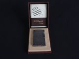 a small black wallet in a box on a black surface