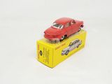 a red toy car sitting on top of a yellow box