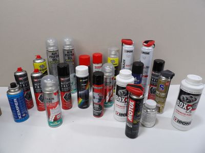 many different types of spray paint on a white table