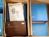 a cardboard box filled with books and binders