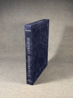 a blue book sitting on top of a table next to a white wall