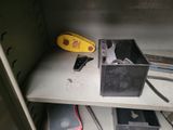 a metal shelf with tools on top of it