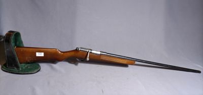 an old rifle with a wooden barrel and a metal handle