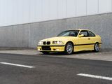 a yellow car parked on the side of the road