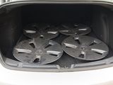 four wheels in the trunk of a car