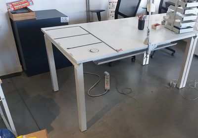a white table with a bunch of sewing machines on it