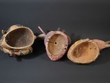 three pieces of pottery sitting on top of a black table