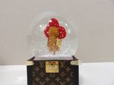 a snow globe with a teddy bear inside of it