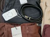 many different types of clothing and accessories laid out on a table
