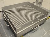a grill that is sitting on the floor in the kitchen