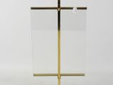 a gold plated metal and glass easer on a white background