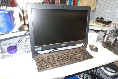 a laptop computer sitting on top of a white desk