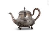 an old silver teapot with a handle on a white background
