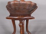 a small wooden table with a shell on it