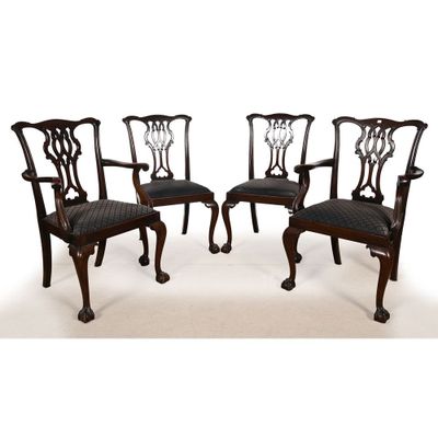 un ensemble de quatre chaises de salle à manger en acajou avec des assises rembourrées de cuir