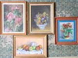 four paintings hanging on the wall of a room