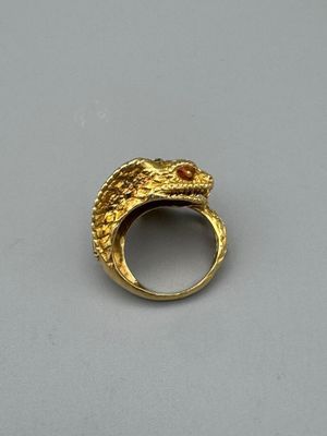an image of a gold ring with a snake on it ' s side