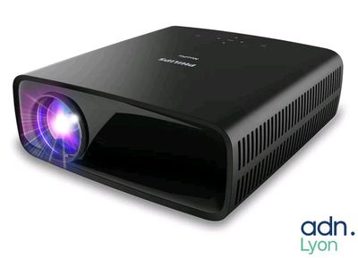 an image of a black projector with a purple light on it