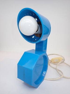 a blue lamp that is on a white table