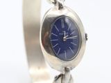 an image of a silver wrist watch with a blue face