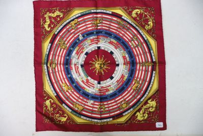 a close up of a red and yellow banda with a clock on it