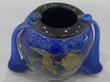a blue vase with a gold leaf decoration on it