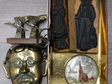 a gold box with a metal object and a bronze mask